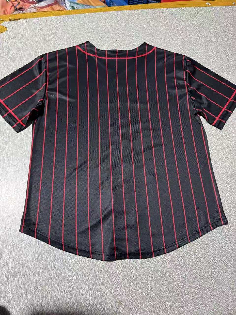 Black and red pinstripe baseball jersey with Black Hills lettering and number 74