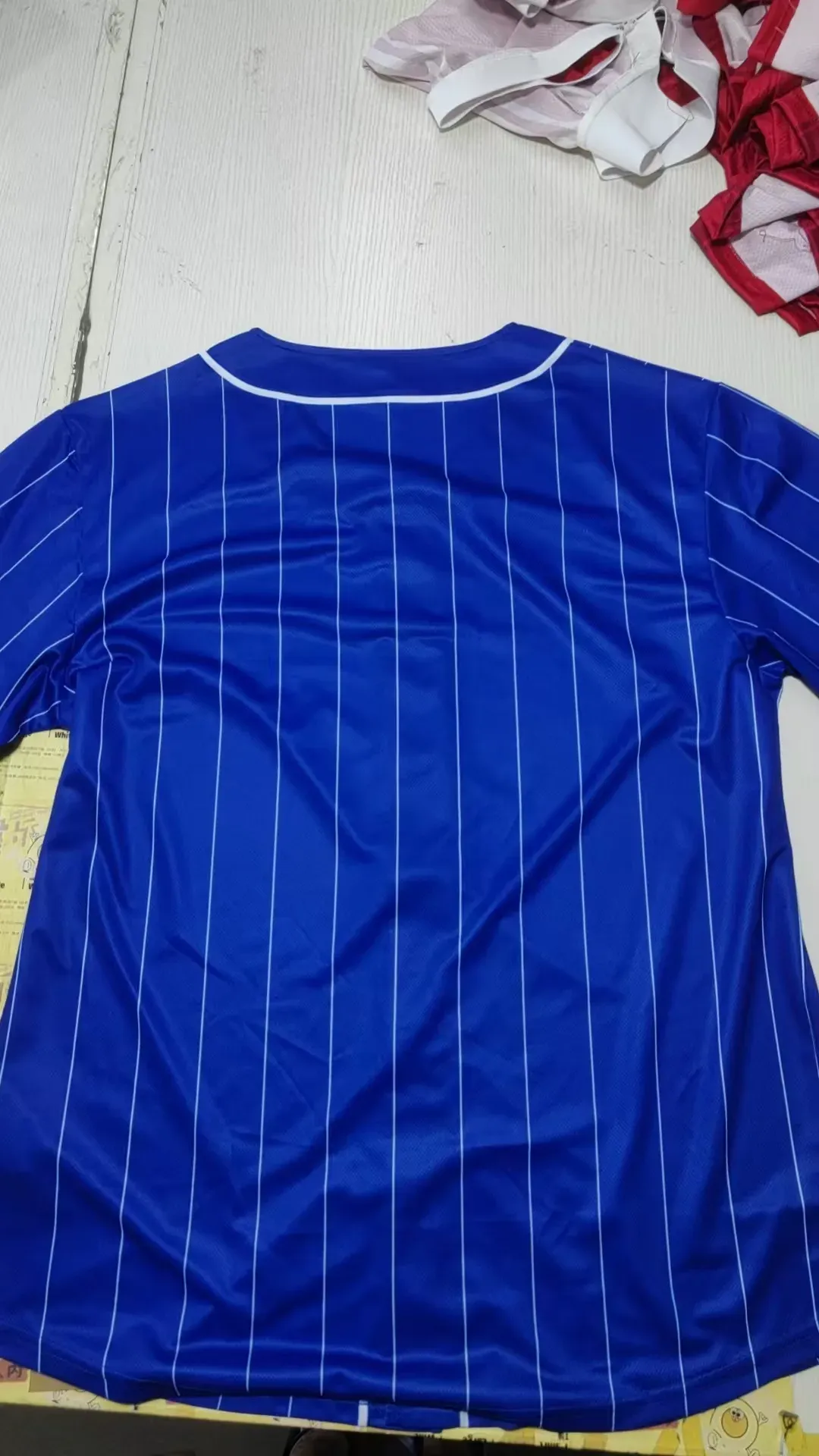 Back of blue pinstripe sublimation baseball jersey with Ms. de Santiago player lettering