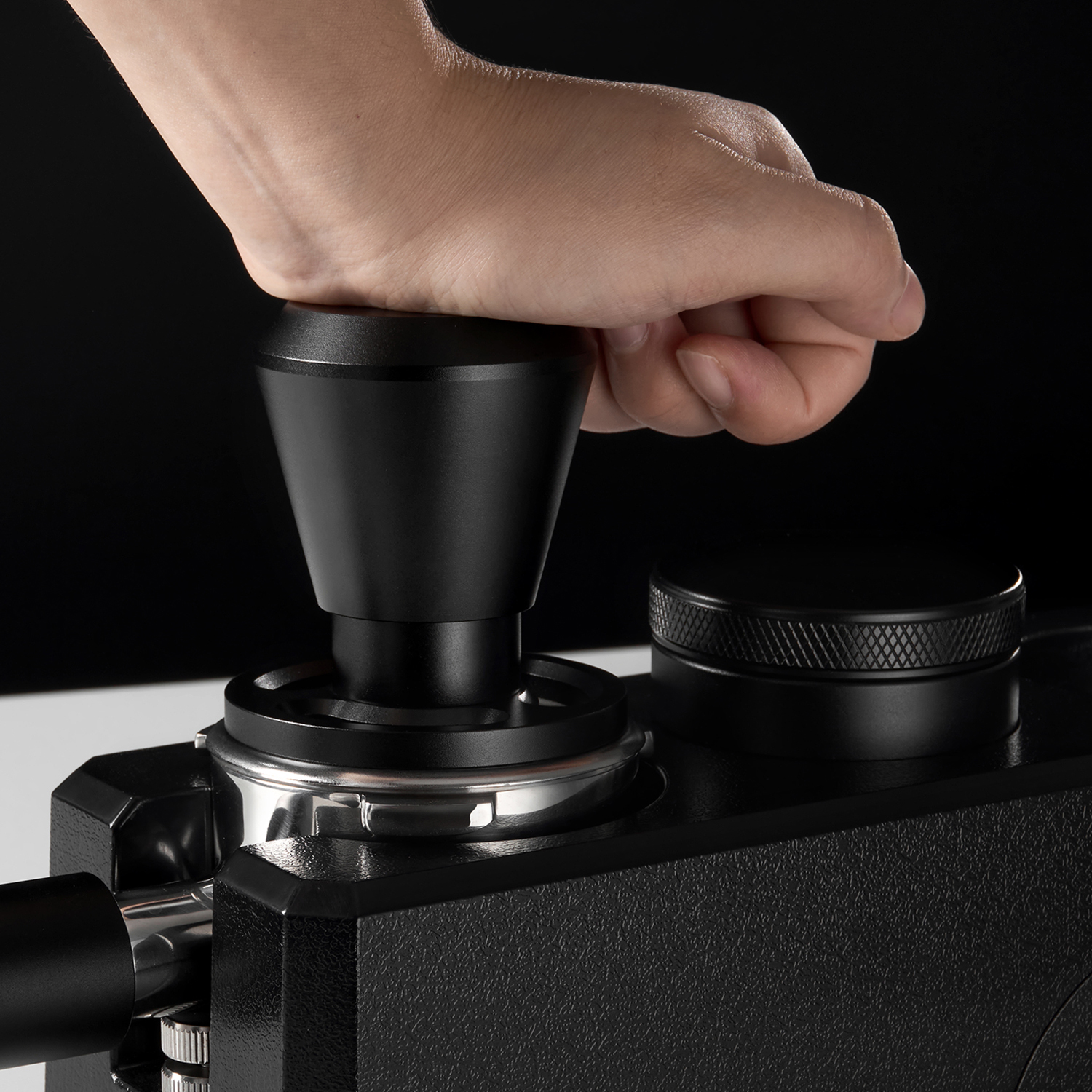 Impact tamper pressed into a portafilter basket