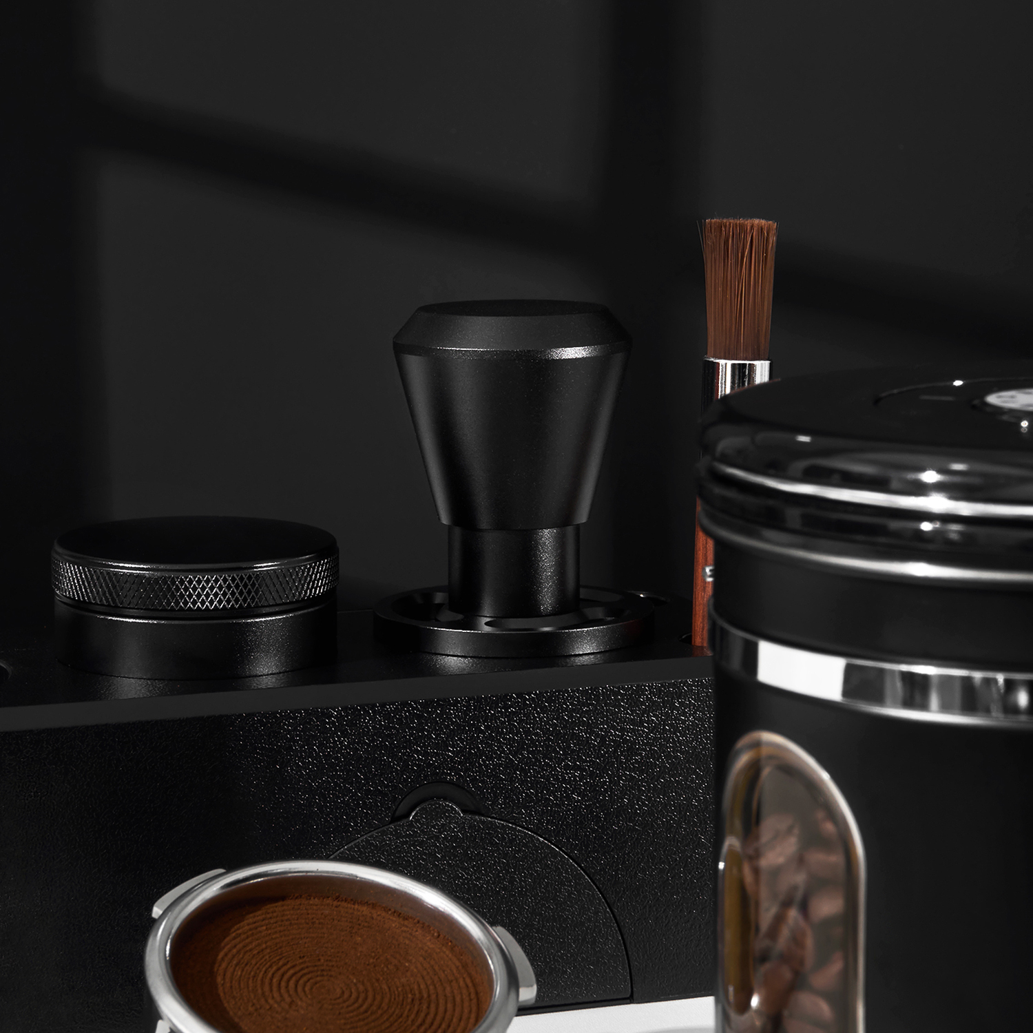 Dark impact tamper beside a prepared basket