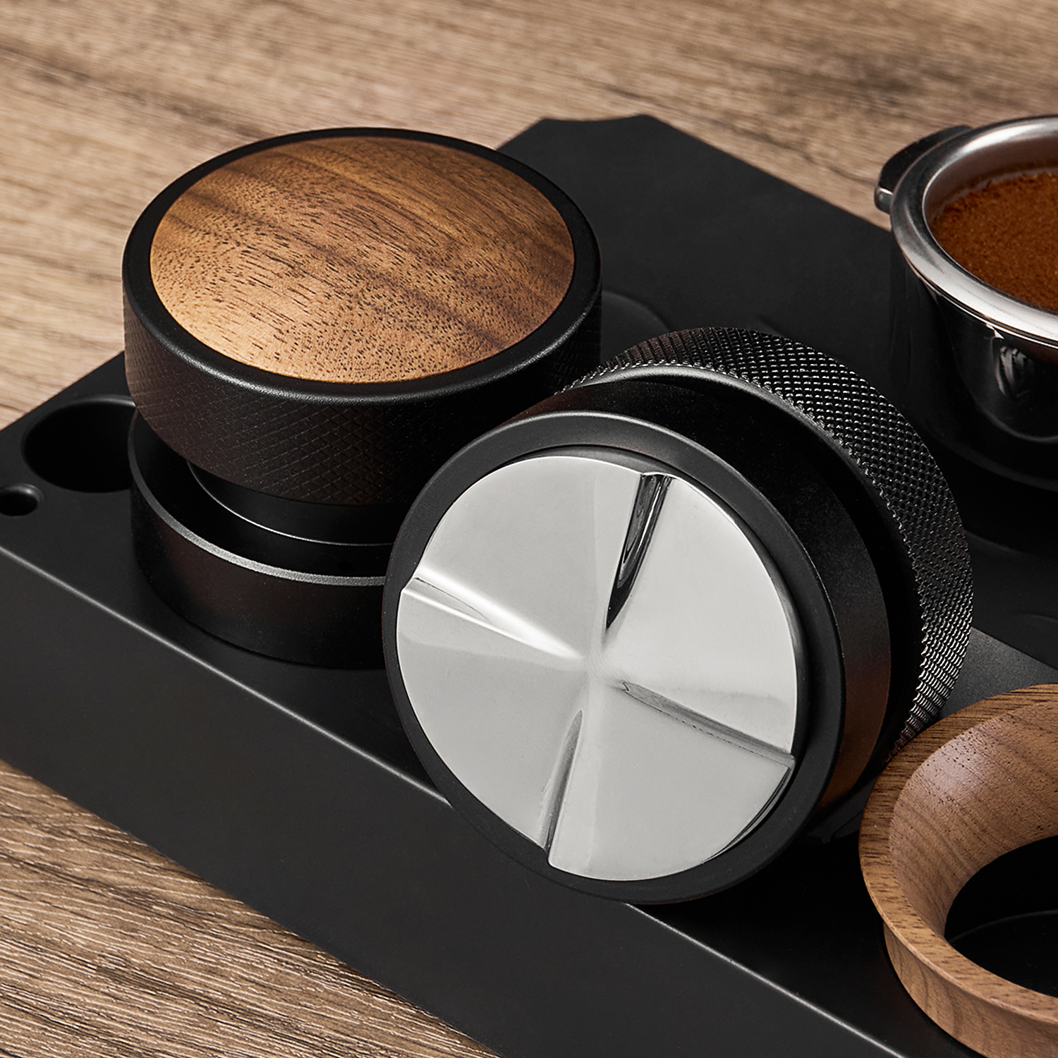Separate walnut-cap espresso tamper and gravity distributor with visible bases