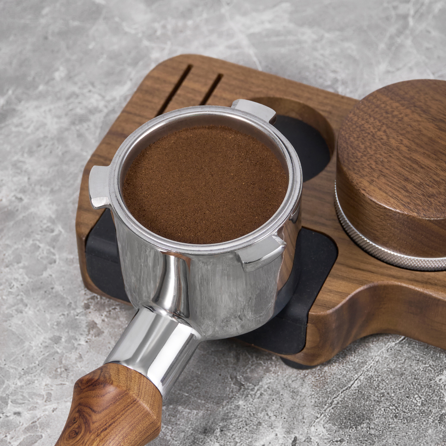 Portafilter basket filled with coffee grounds