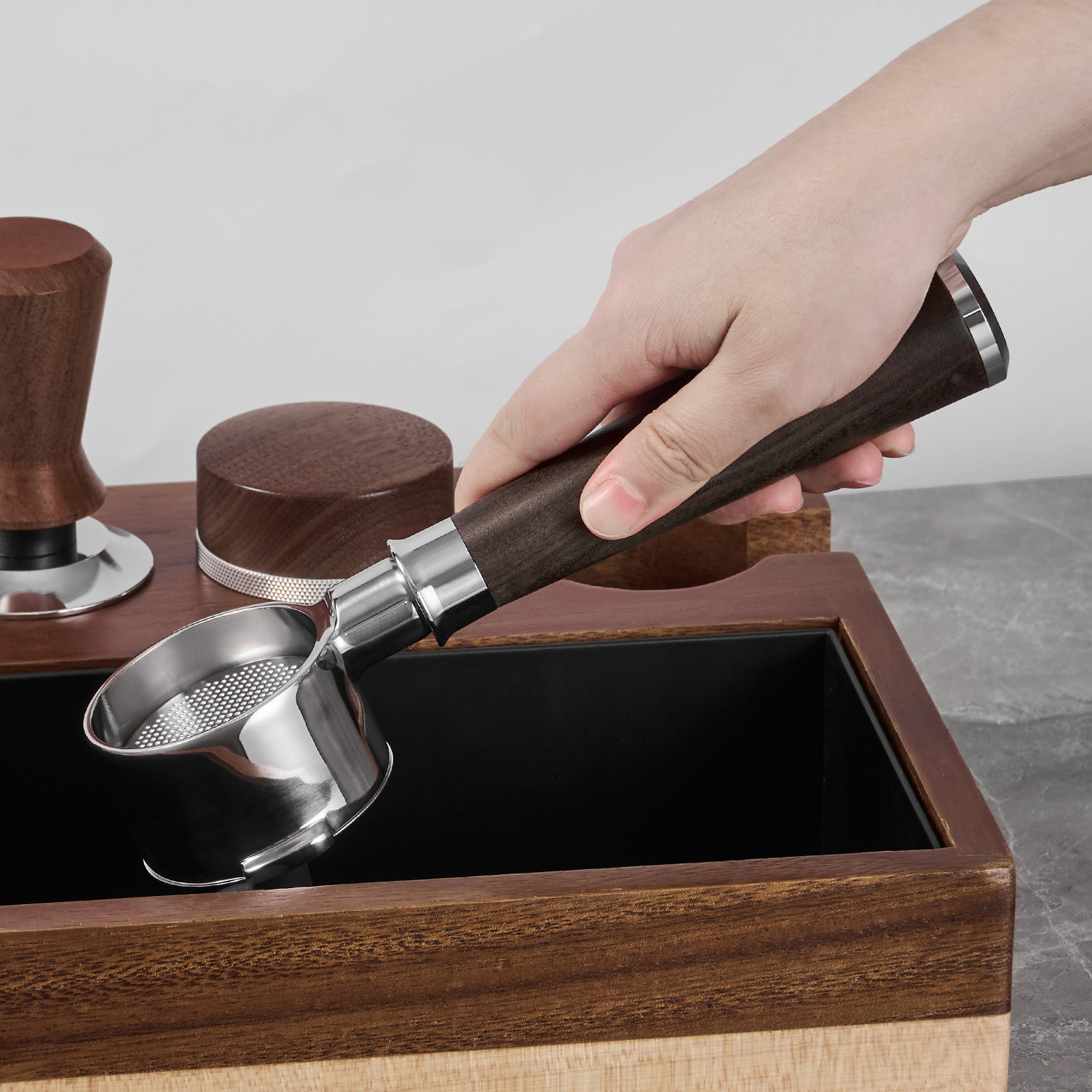 Two-lug portafilter used beside a knock box