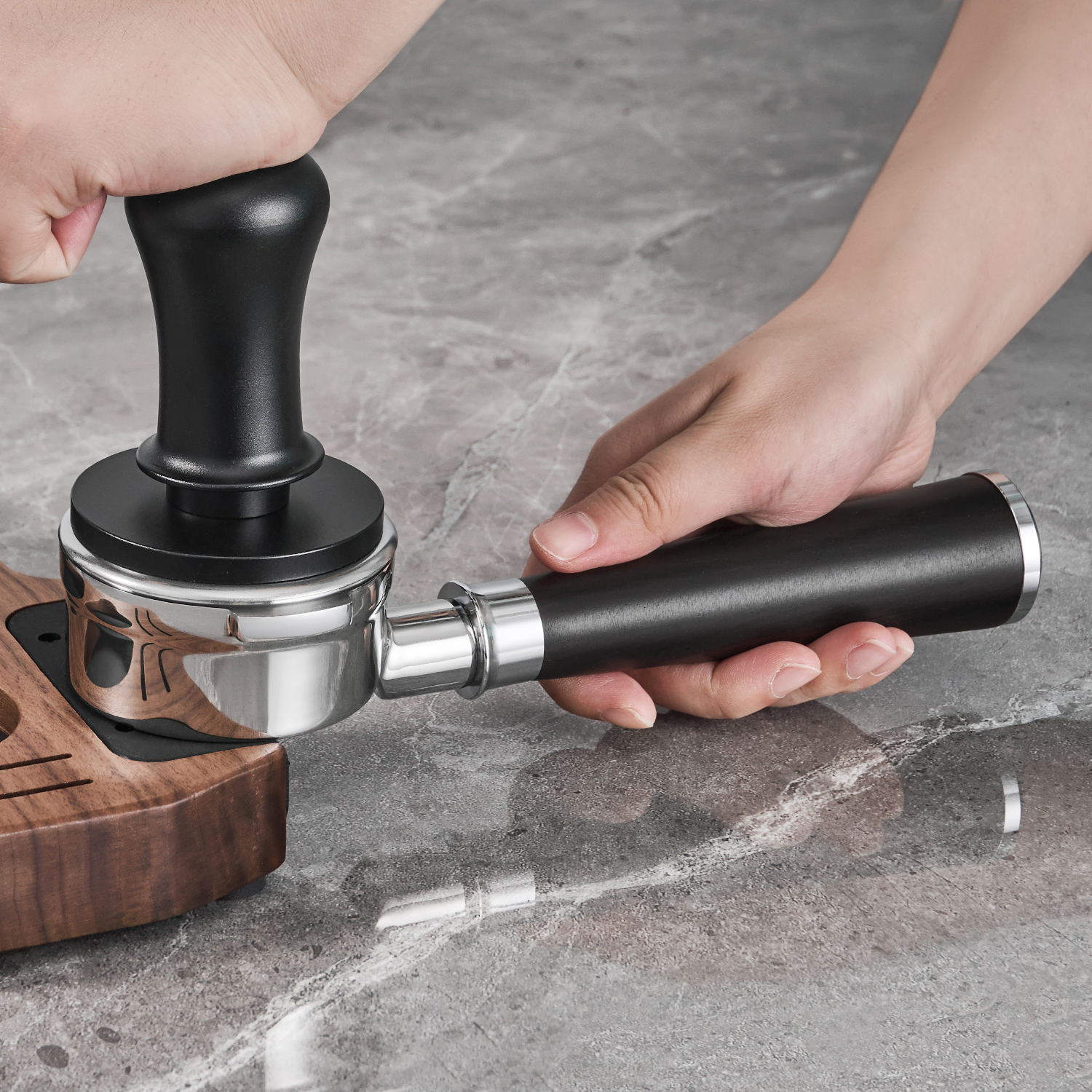 Portafilter held while tamping