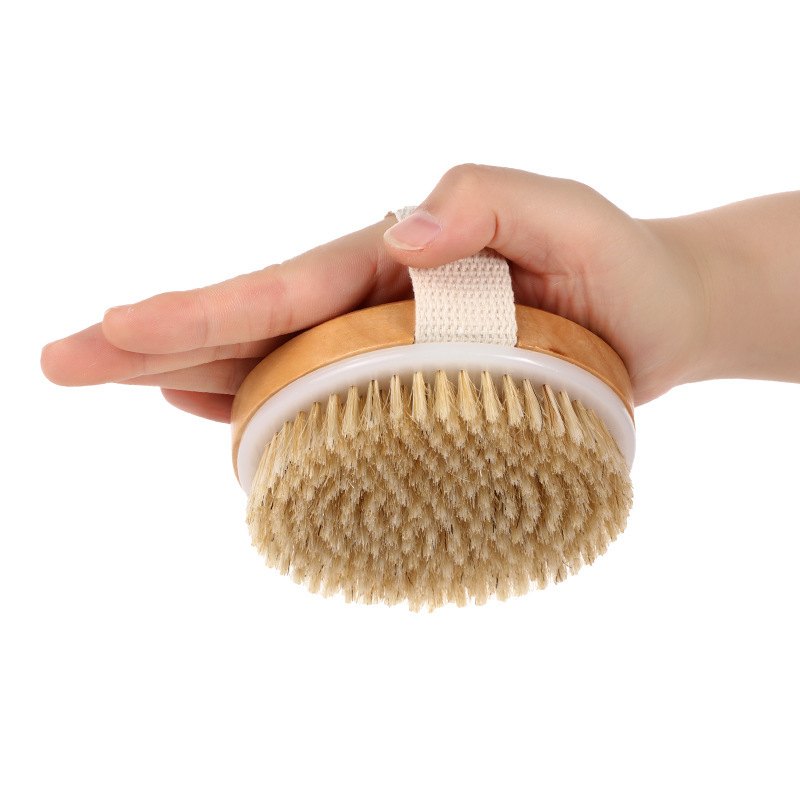 Holding the boar bristle brush with soap lather during shower use