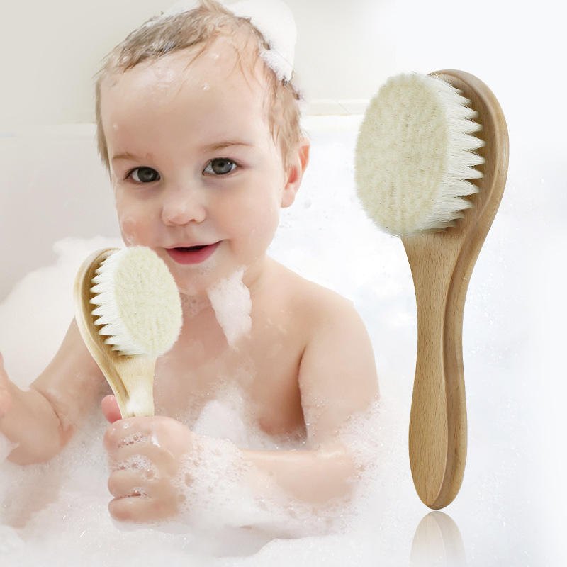 Baby using the wool brush during bath time