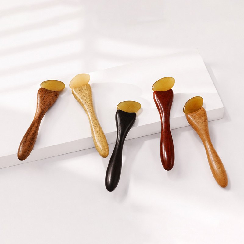 Handcrafted facial massage stick in five natural wood colours