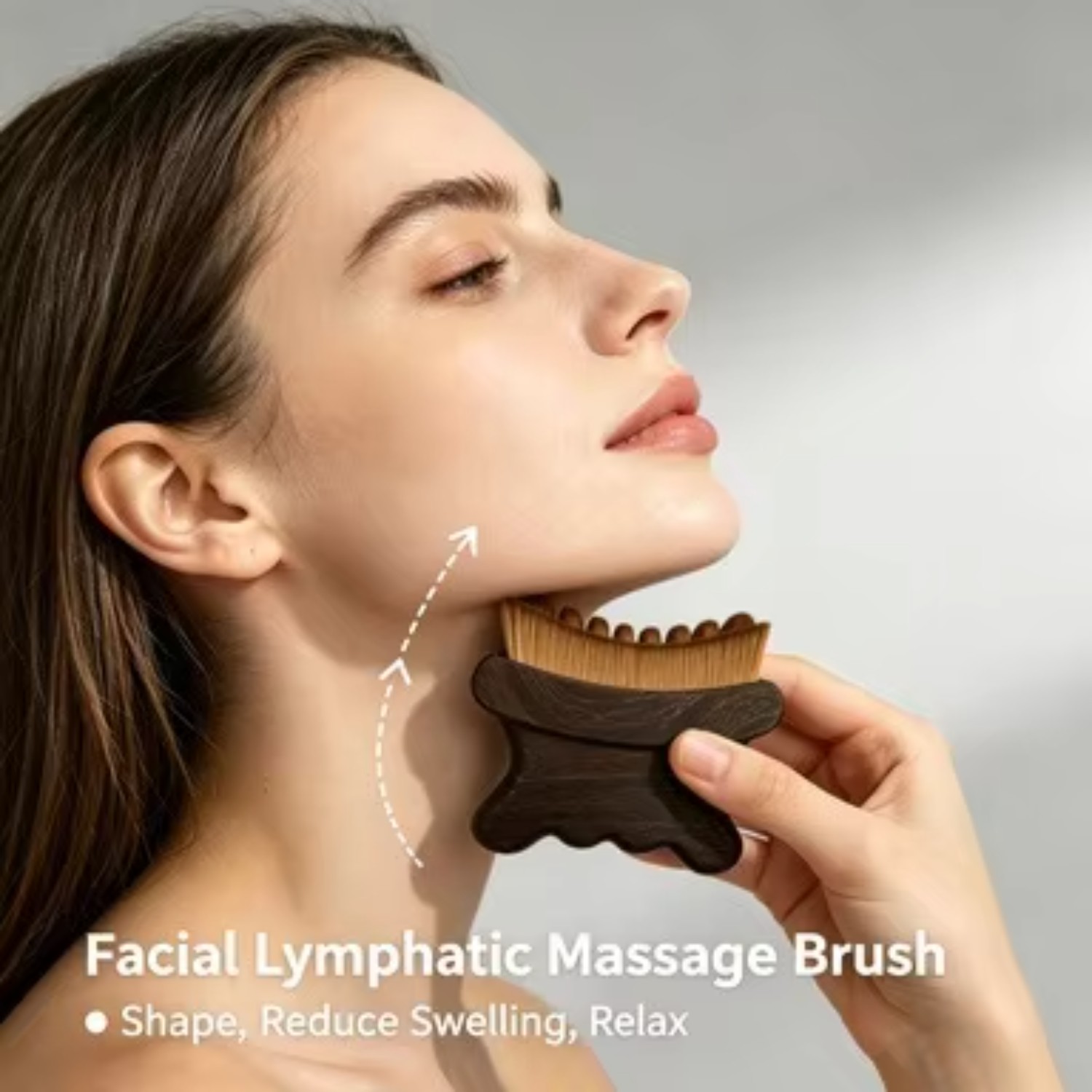 Facial lymphatic massage brush on the jawline and neck