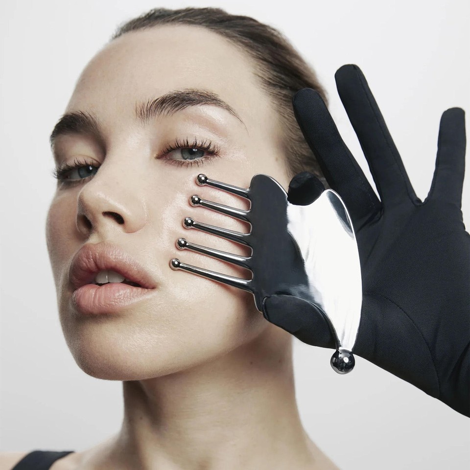 Stainless steel comb in use along the cheek and jawline