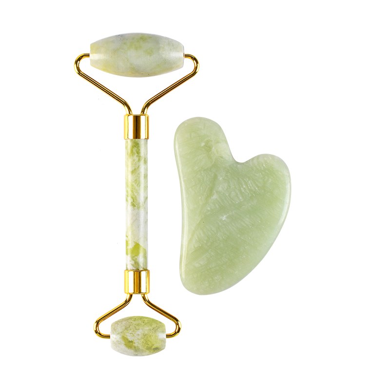 Green jade roller and board set on white