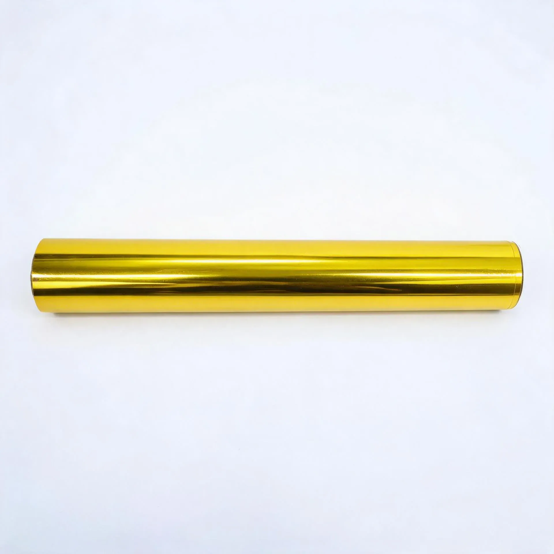 Gold coffee-tone hot stamping foil roll on a white background