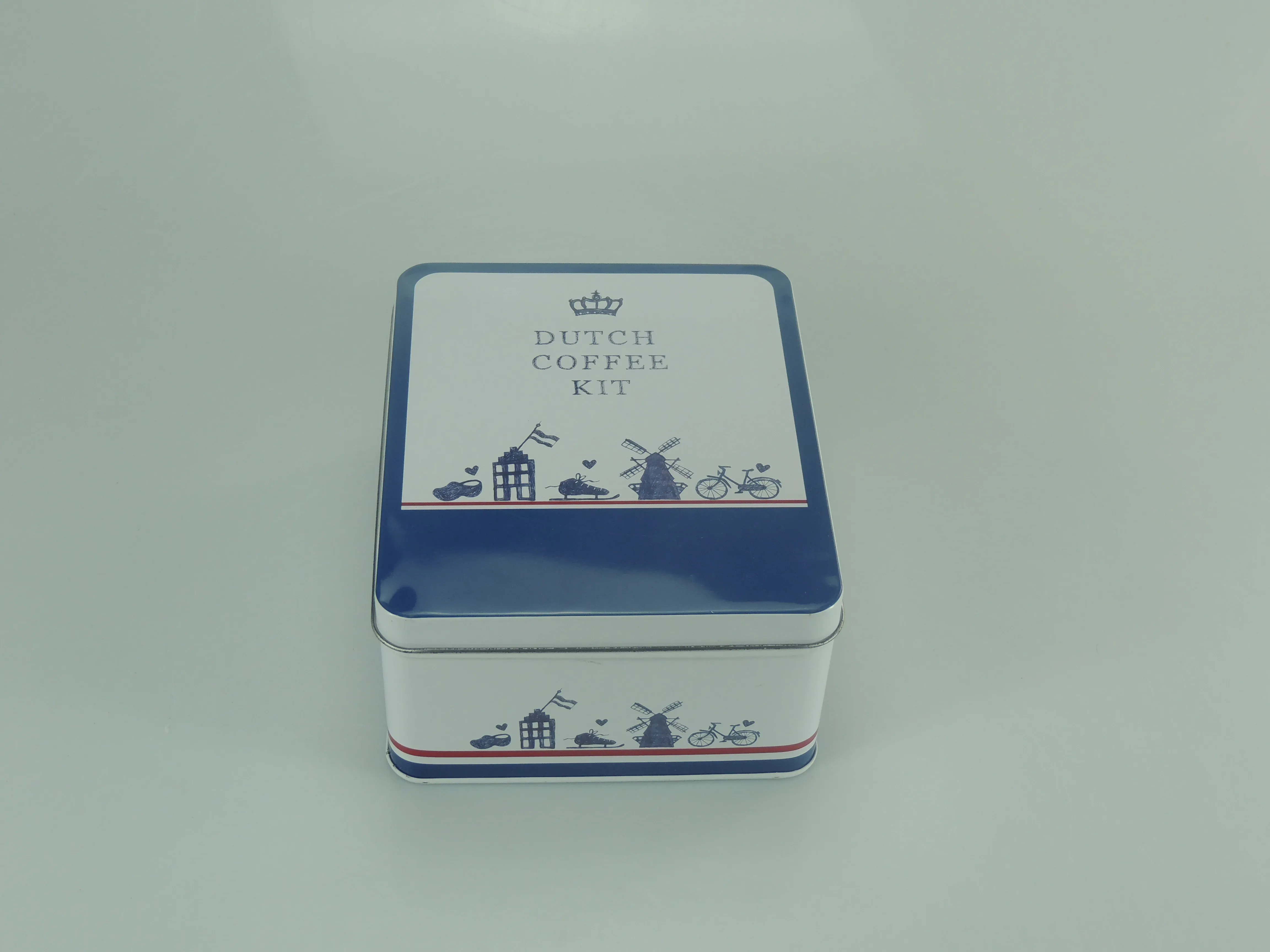 Square gift tin lid printed with the coffee-kit design in blue and white