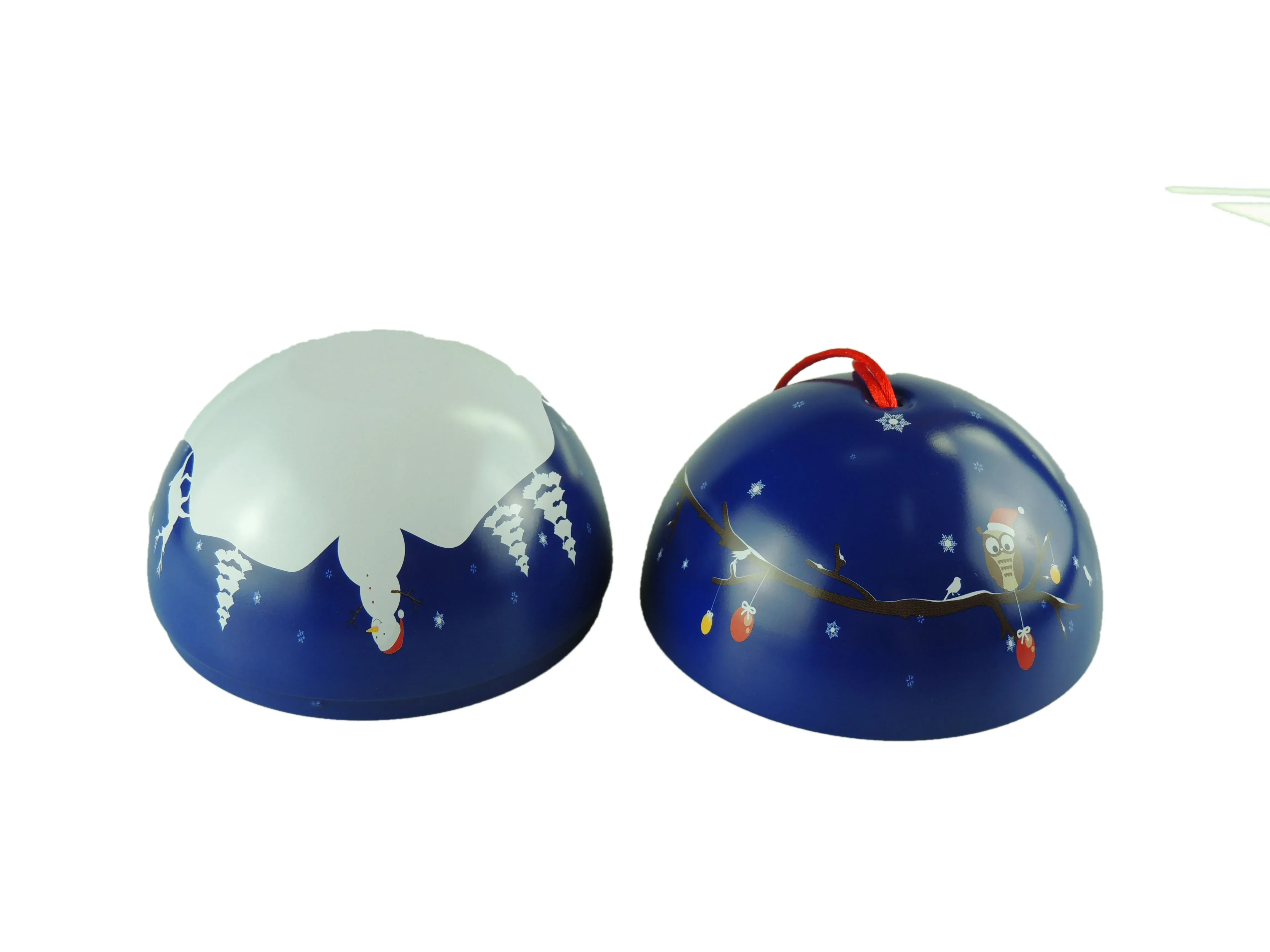Christmas ball tin turned to show both prints: a blue night sky with an owl on one side and a snow swirl on the other