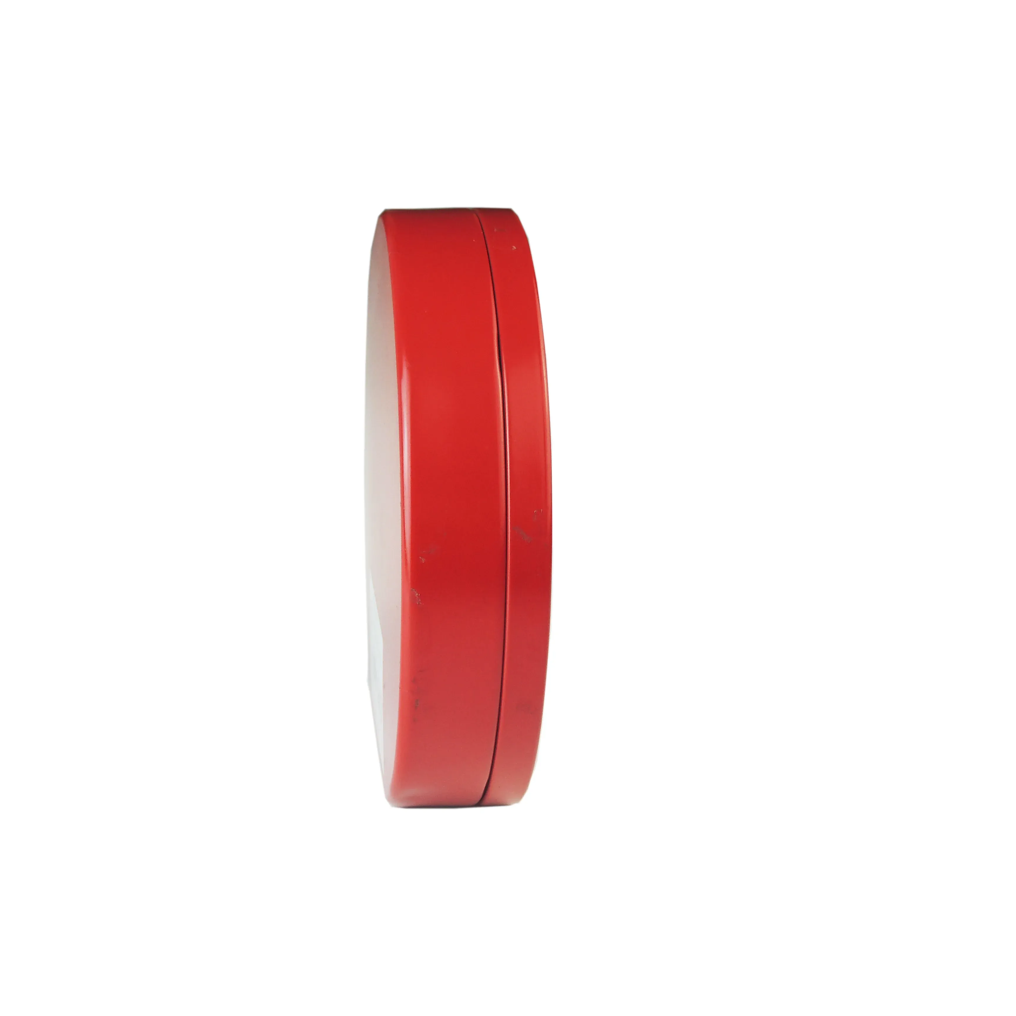 Round red tin standing on edge showing the slim profile, on a white background