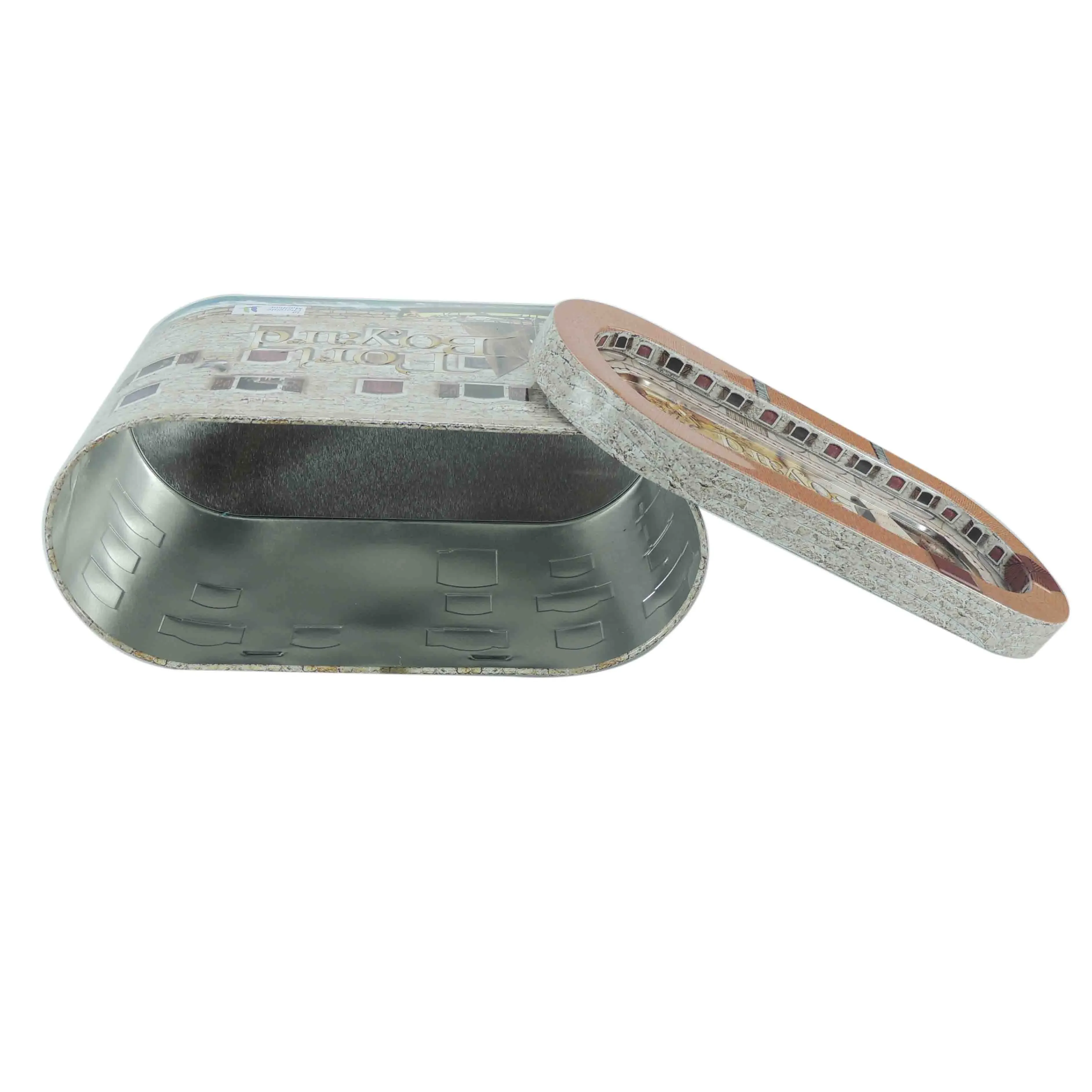 Fort-shaped tin opened, showing the tinplate interior with the printed lid beside it