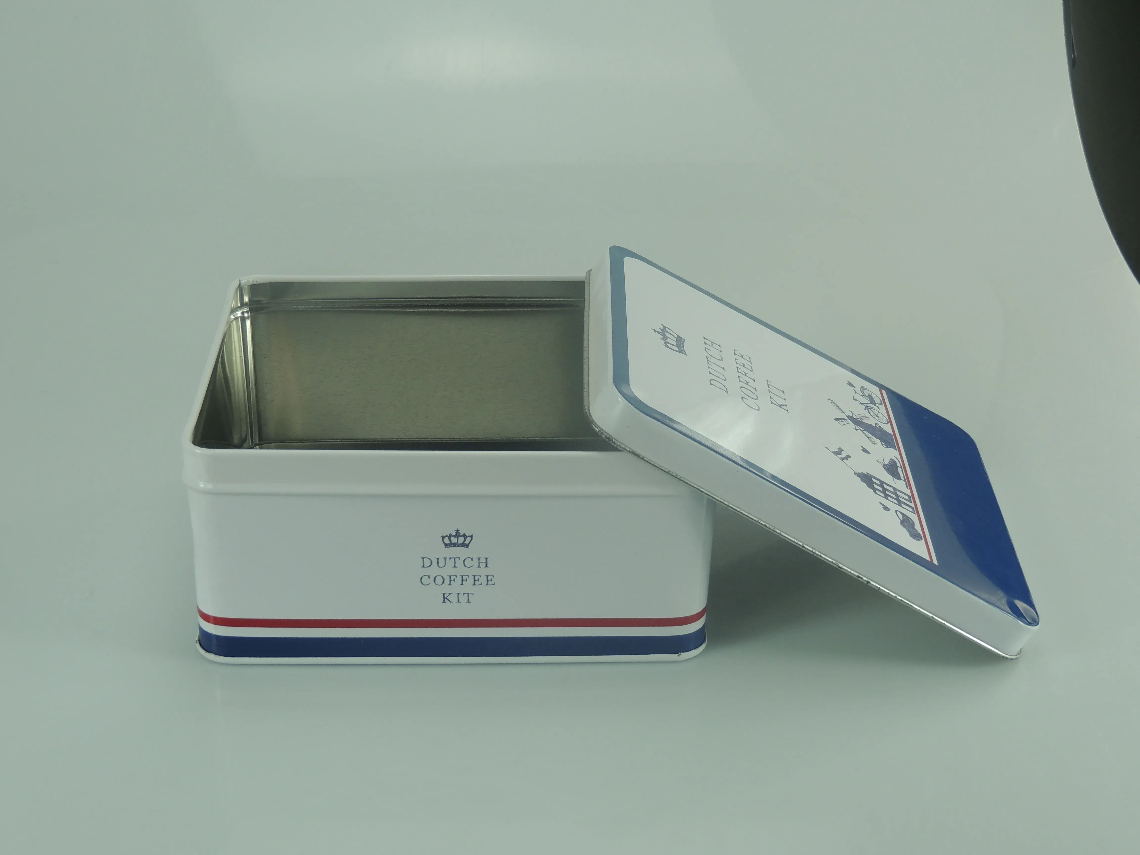 Square coffee-kit tin opened, showing the tinplate interior