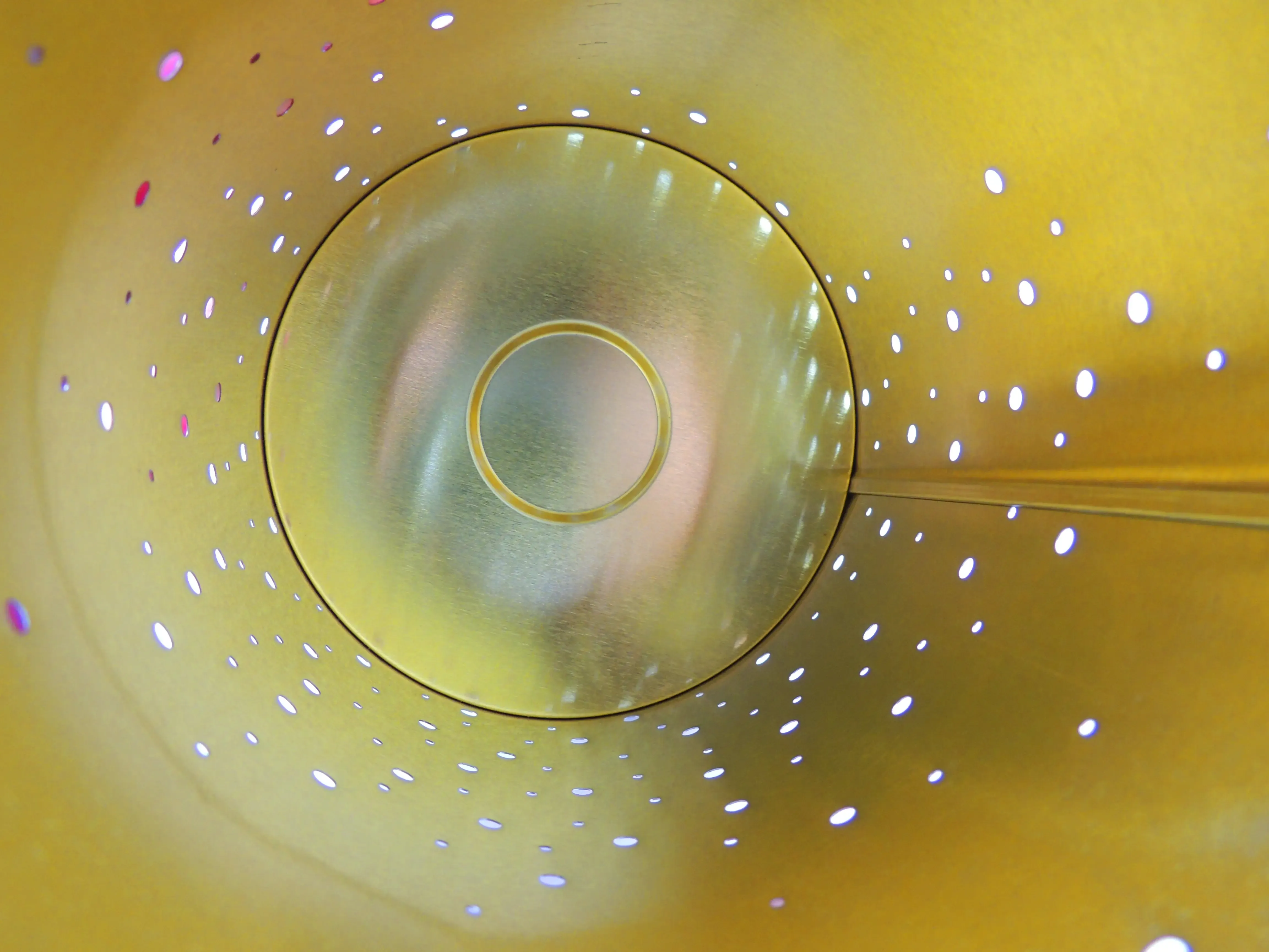 Top view into the gold-lined interior of the round candle tin