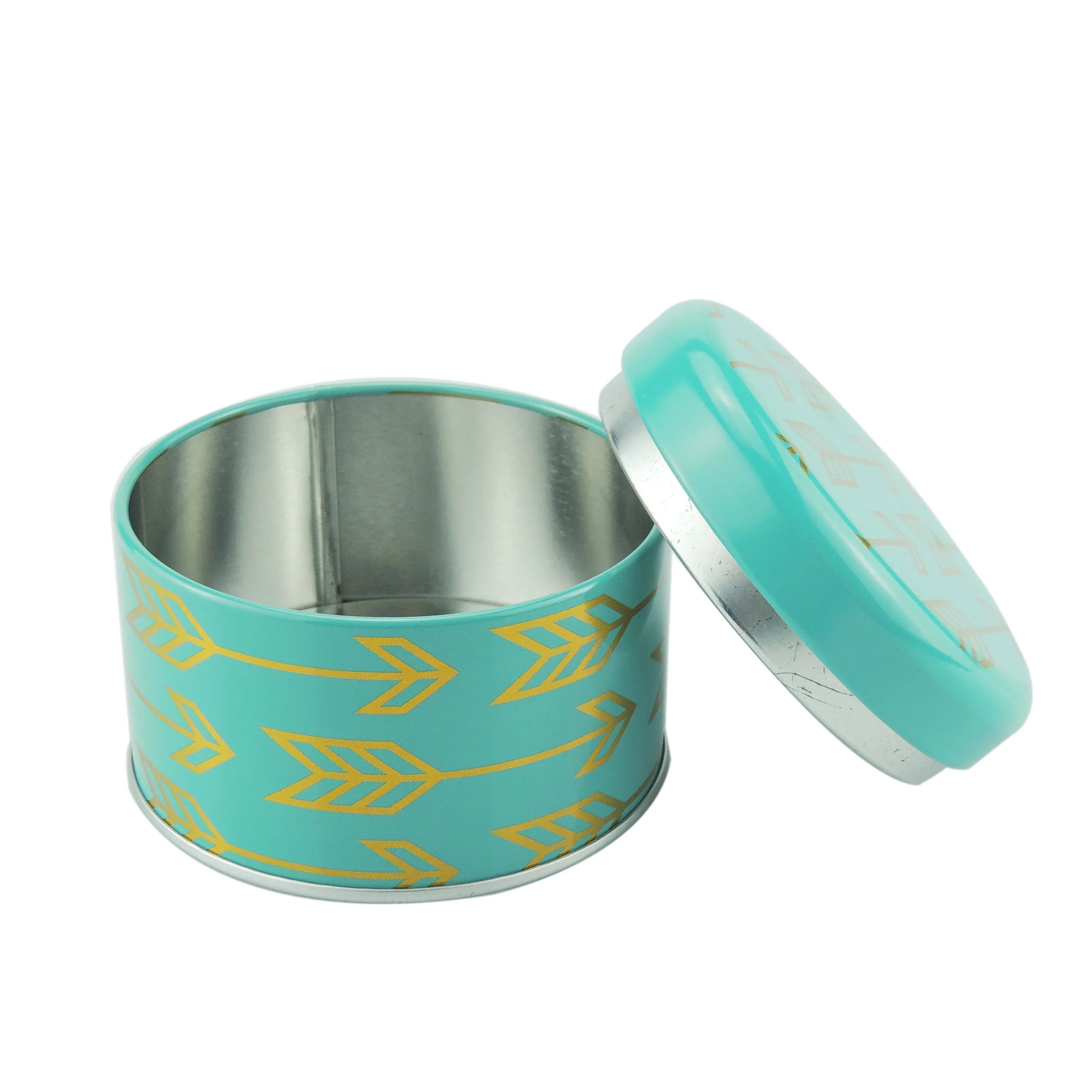 Round tea caddy opened, showing the tinplate interior with the printed lid beside it