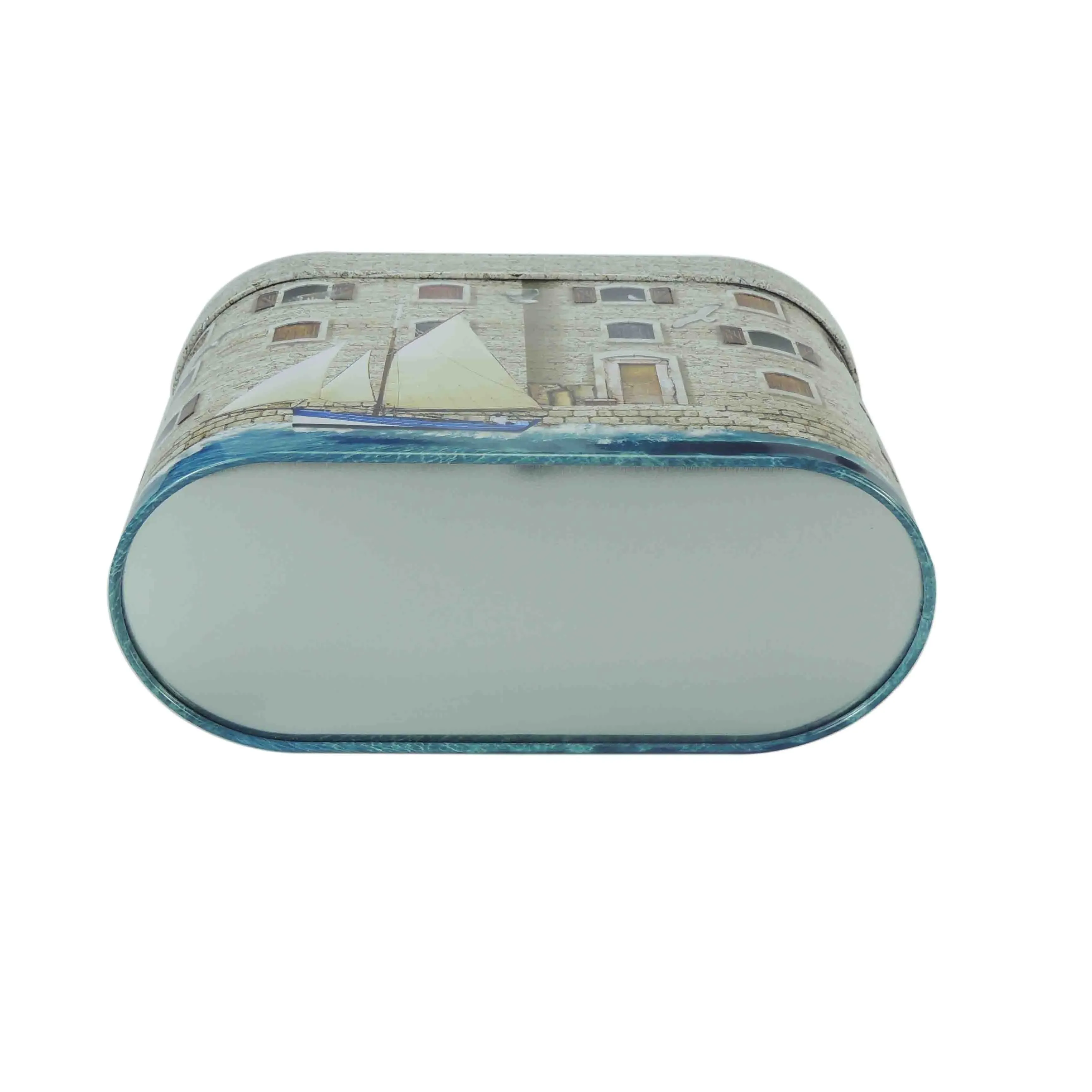 Fort-shaped tin from the back, showing the oval base and the blue water print