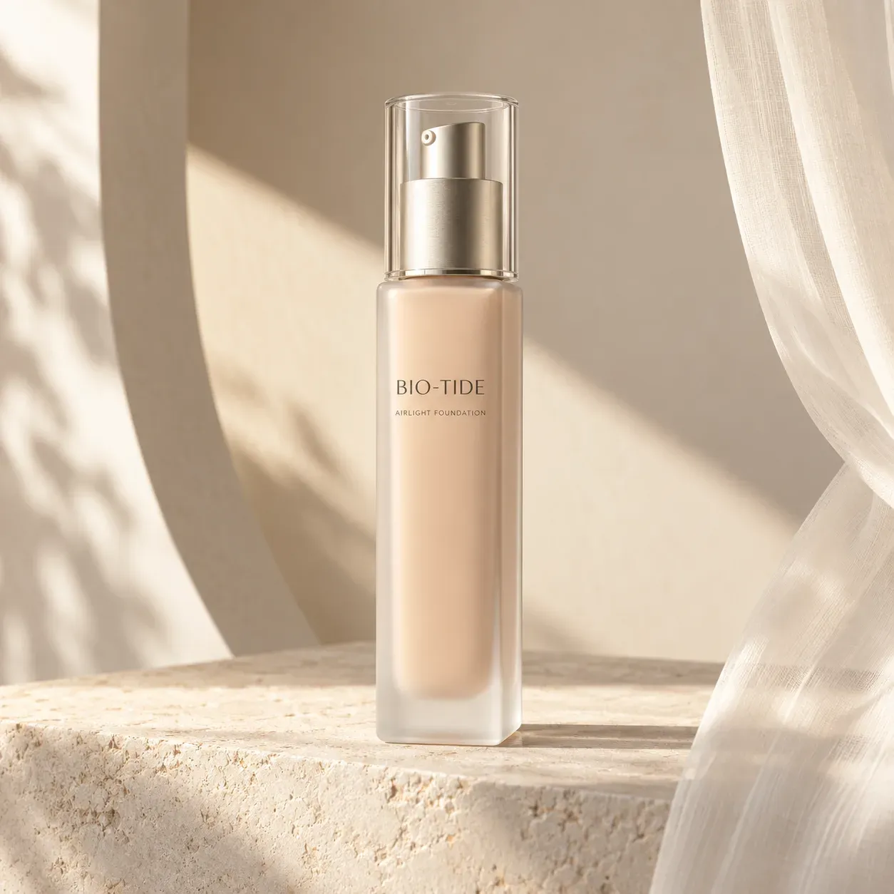 Tall BIO-TIDE ivory foundation bottle in a warm architectural studio