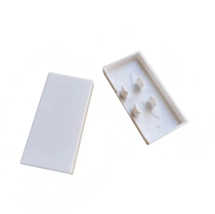 White rectangular plastic covers showing the exterior surface and internal attachment features
