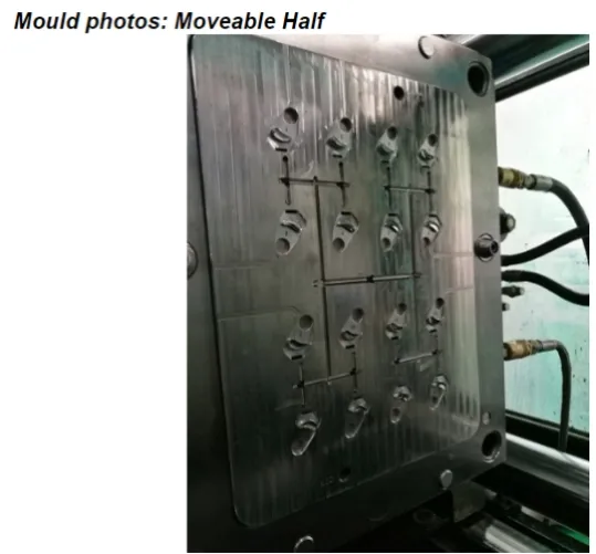 Movable half of a JST 16-cavity injection mold showing cavity layout and cold-runner channels during T2 trial
