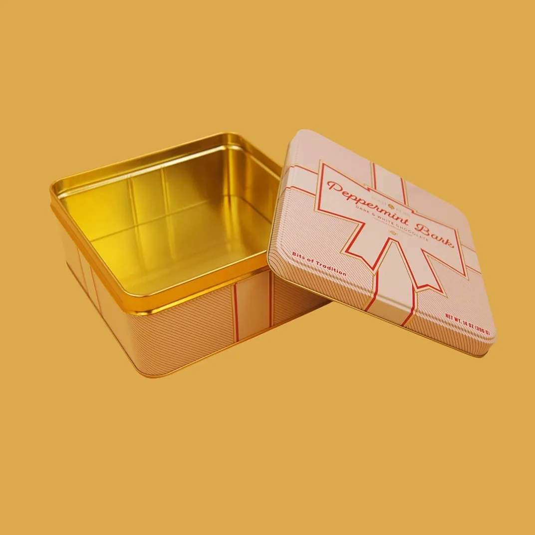 open pink gift box shaped tin with gold interior for candy, cookies or promotional gifts