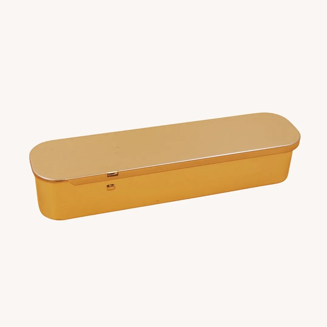 Long narrow gold tin box closed view