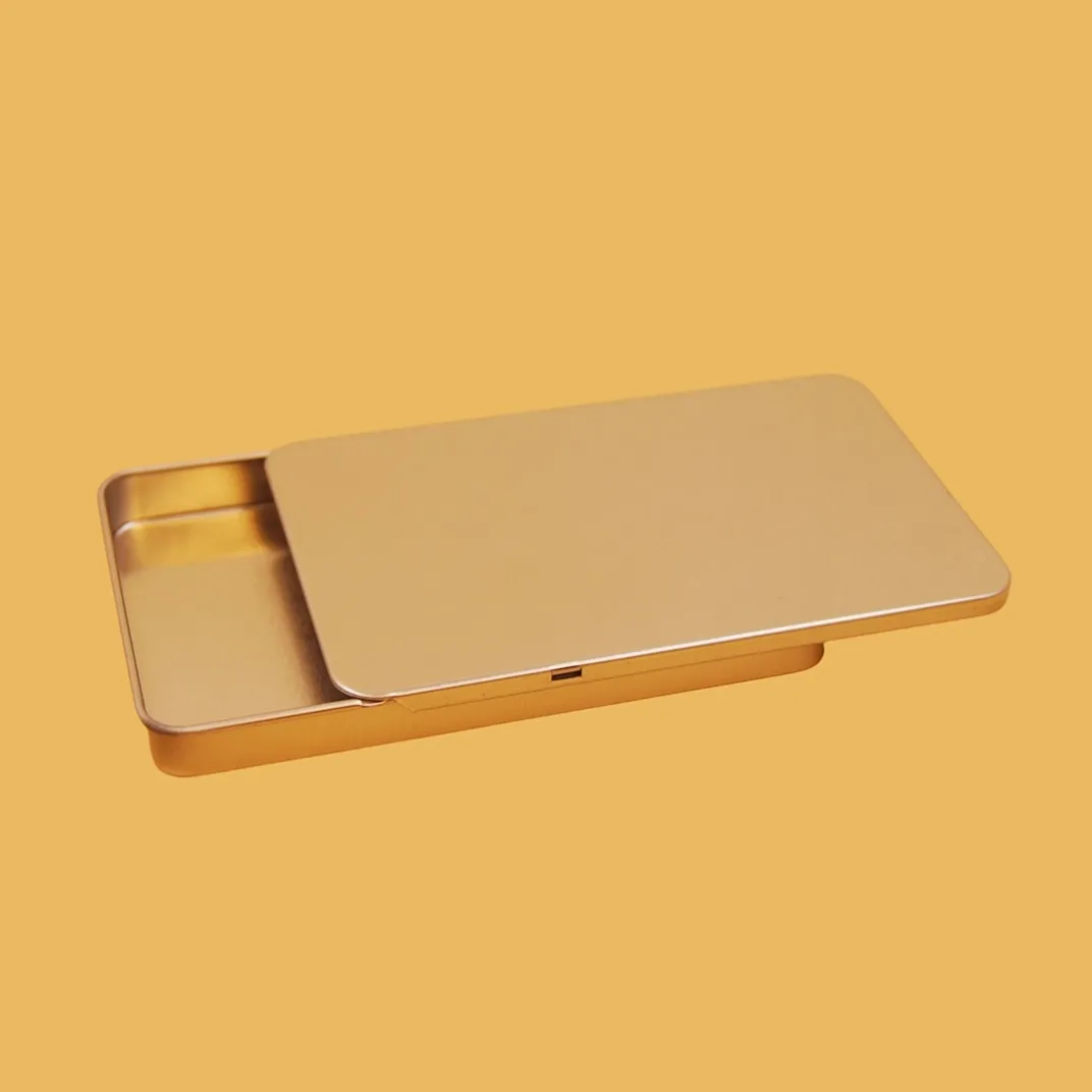 Open flat rectangular gold tin box with sliding lid