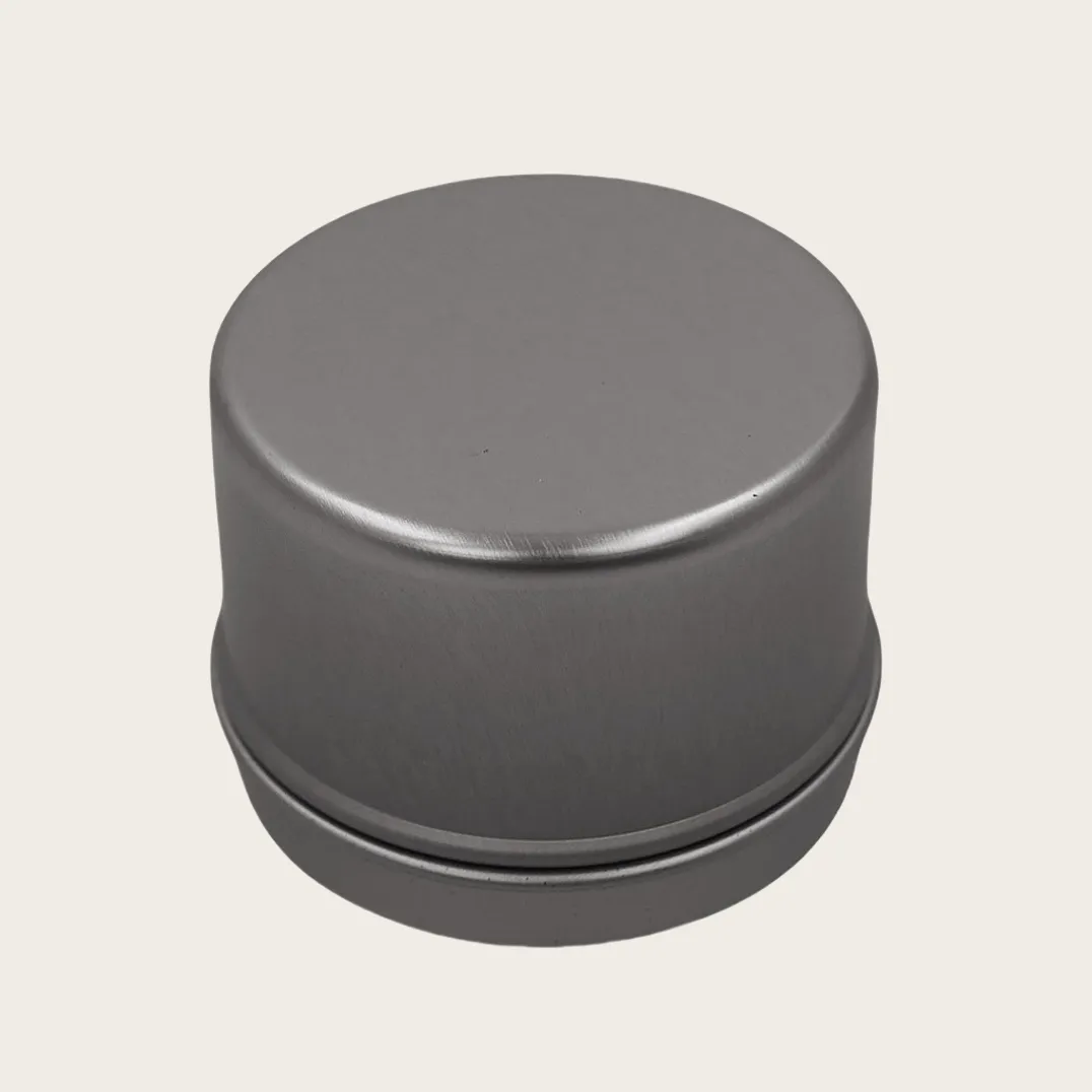 Round silver tin canister side view