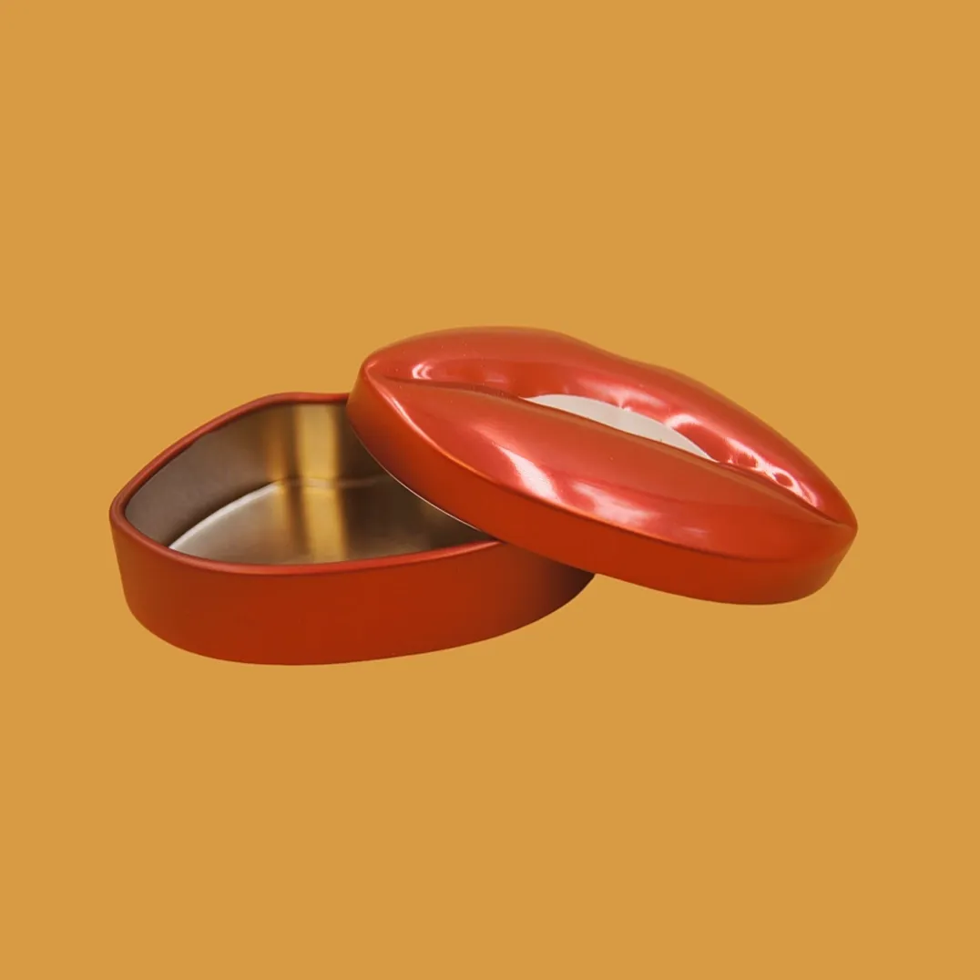 Open red lips tin box with gold interior