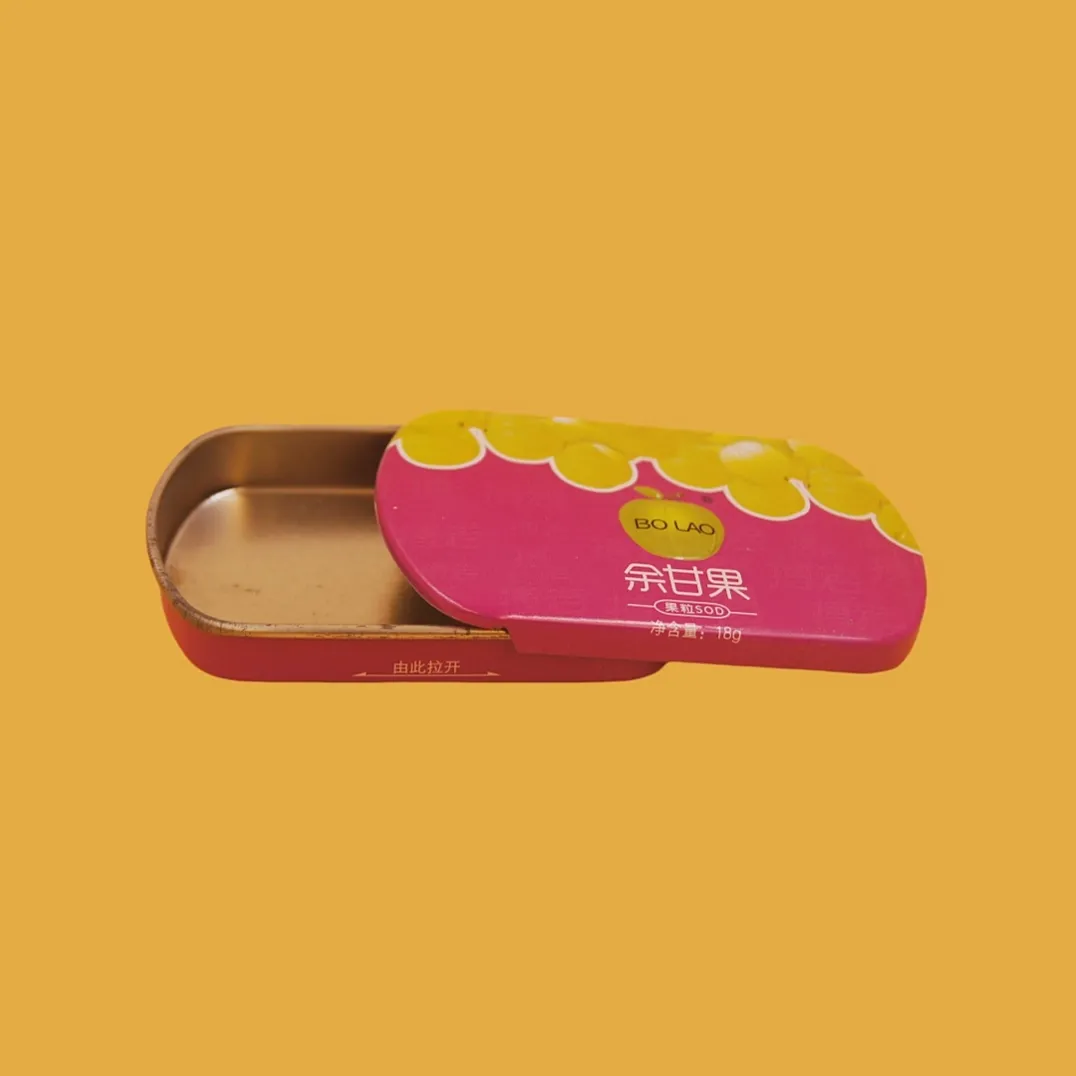 Open pink sliding tin box with gold interior