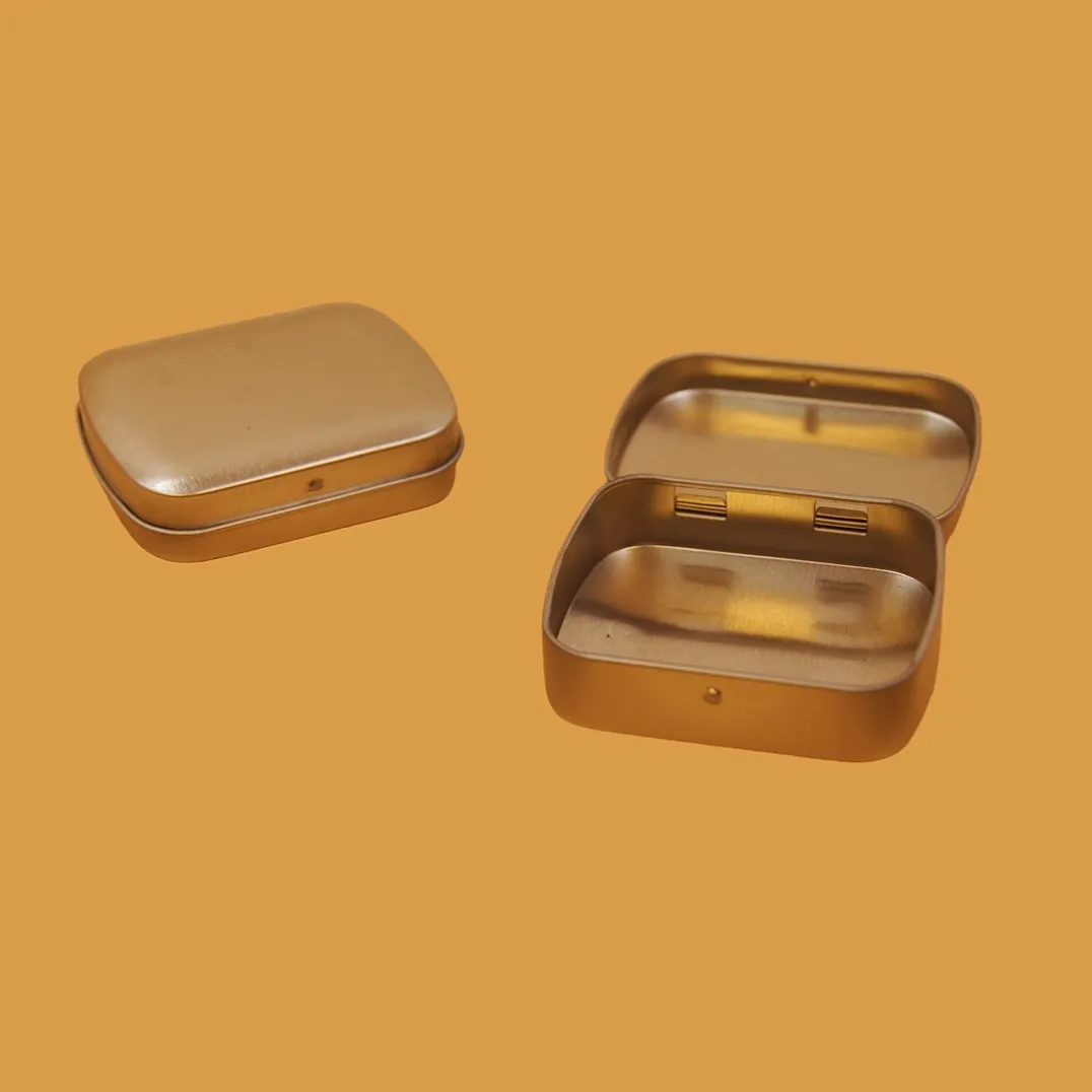 Open small square gold tin boxes with compartments