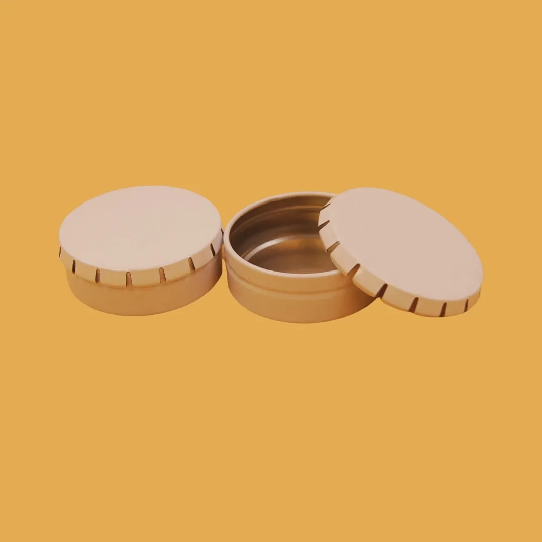 Open round peach tin box with ribbed side wall