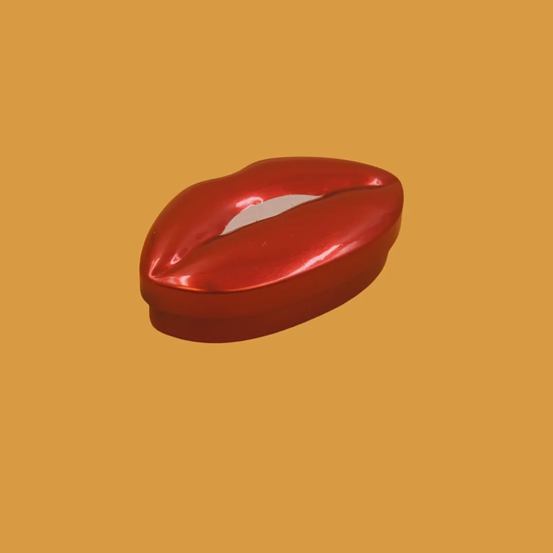 Red lip shaped tin box closed view