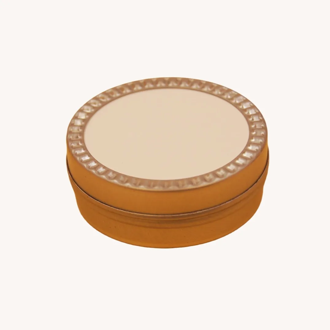 Round gold tin box with decorative ring lid