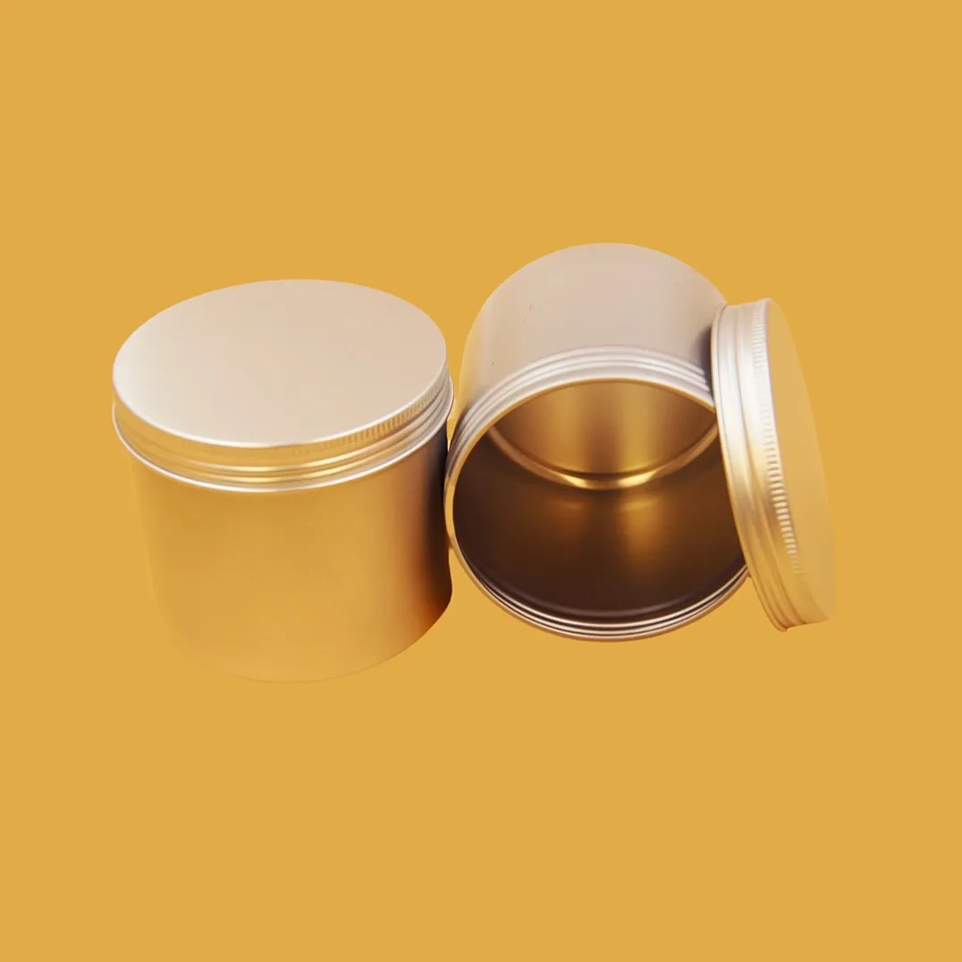 open small round gold tin container with loose lid and metallic interior
