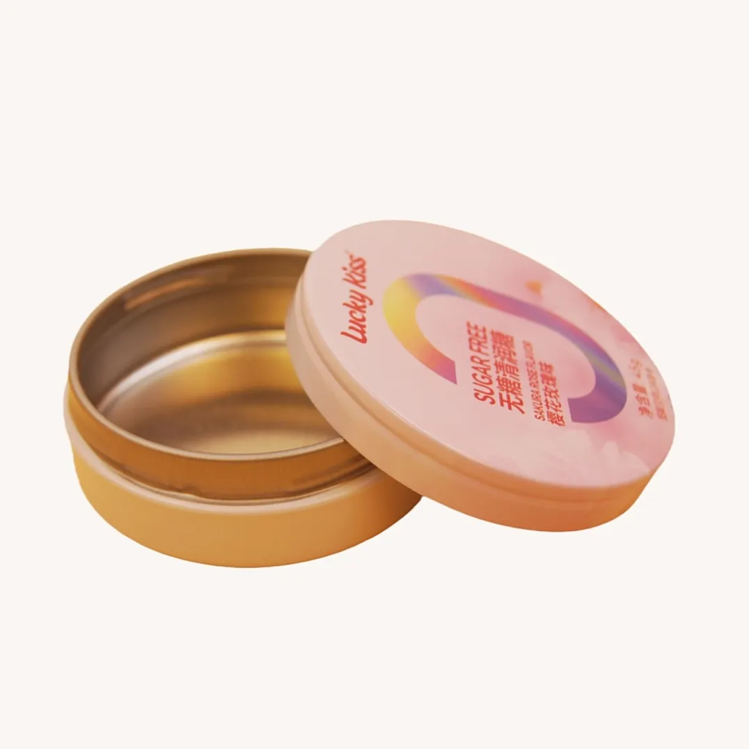 Open round pink candy tin box with gold interior