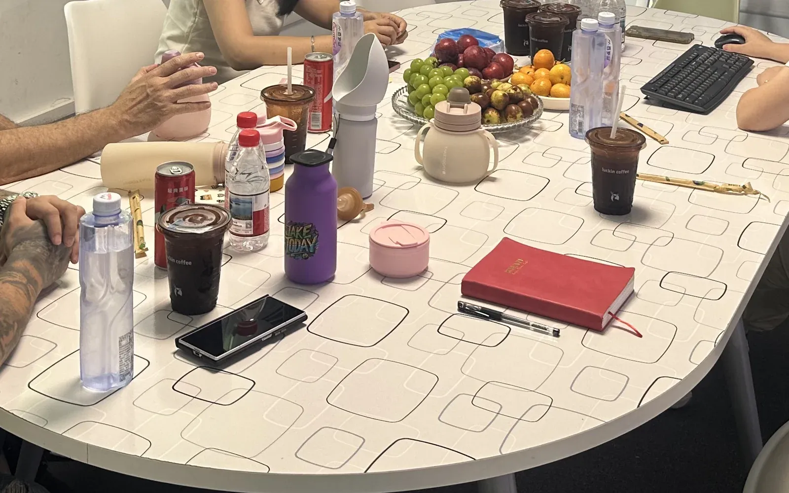 European buying delegation reviewing samples at a factory meeting