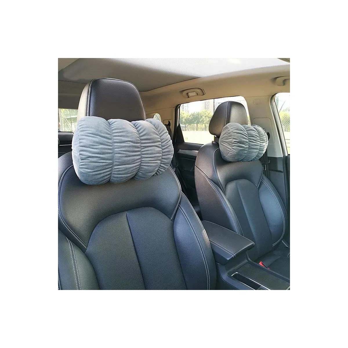 Gray car neck pillow on a seat headrest
