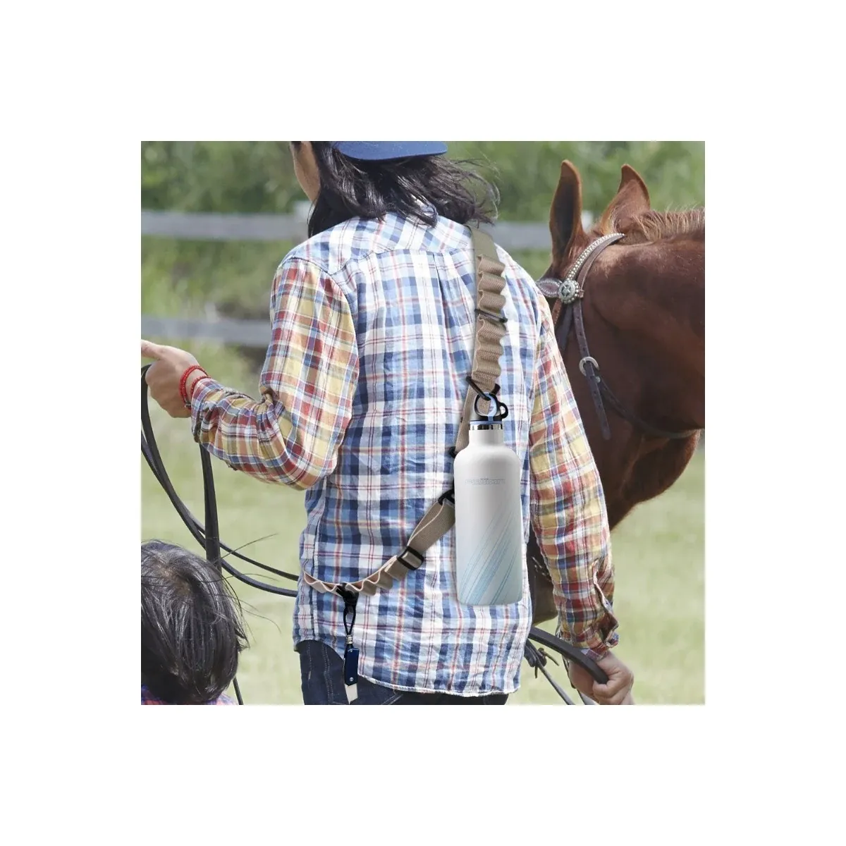 Utility lanyard holding a water bottle outdoors