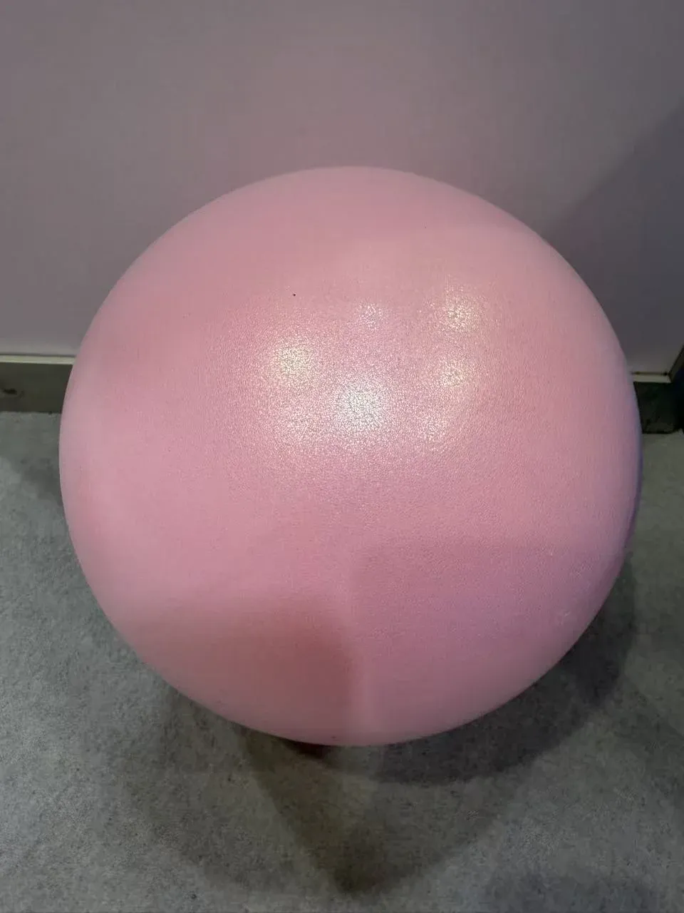 Small pink yoga ball for Pilates with a smooth finish