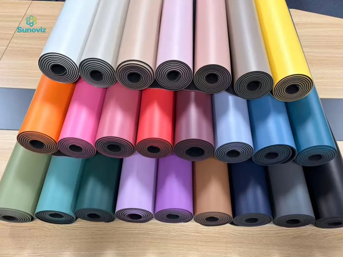 Rolled PU yoga mats in assorted colors stacked in rows