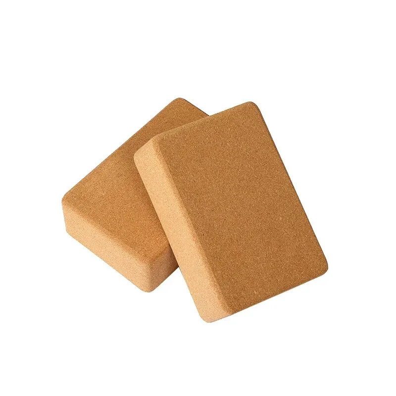 Two high-density cork yoga blocks in natural cork, rectangular with rounded edges