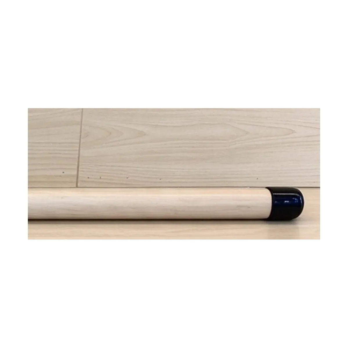 Right end of the maple wood Pilates training stick showing the black anti-slip end cap