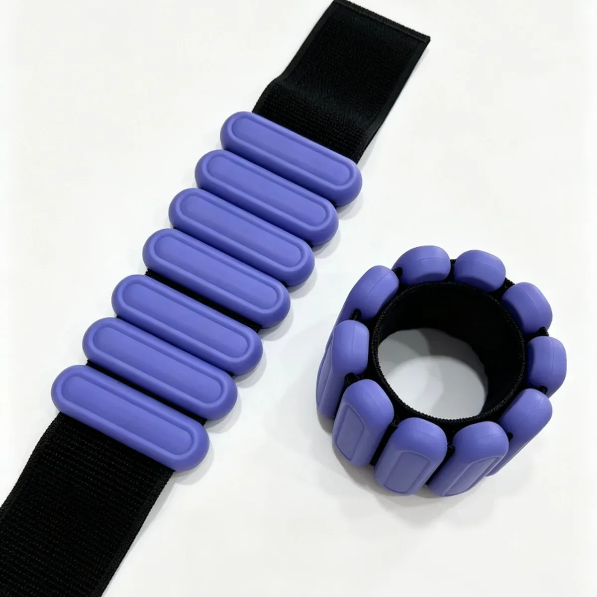 Purple oval ankle and wrist weights with rounded blocks, one strap flat and one closed into a ring