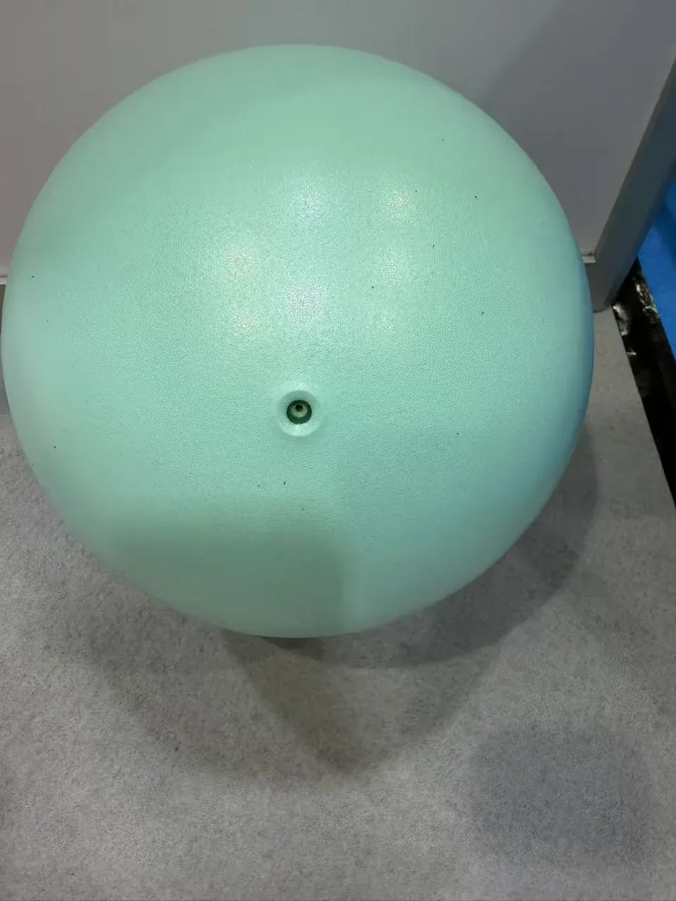 Small mint-green yoga ball for Pilates with a smooth finish