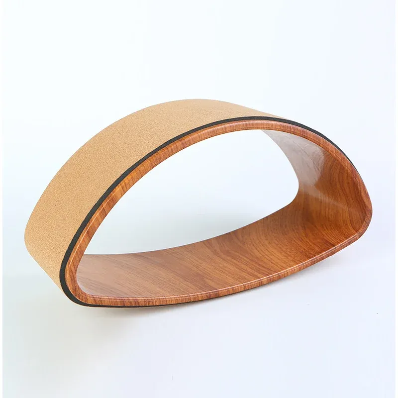 Shaped cork yoga wheel with a wood-grain rim and a natural cork outer surface, on a white background