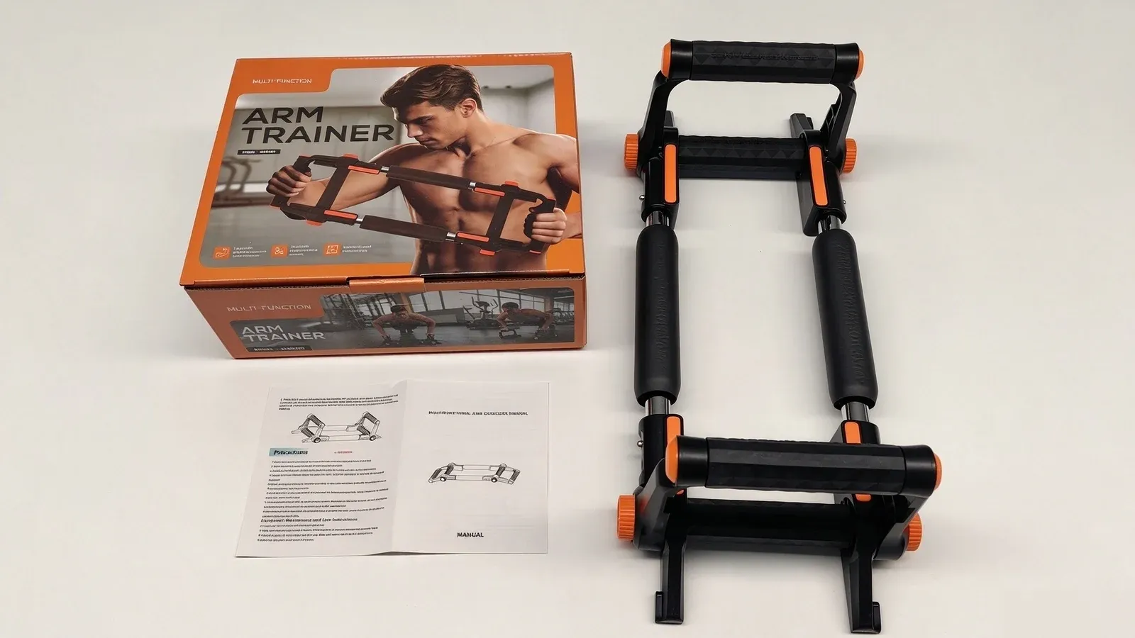 An orange and black arm trainer carton, an adjustable push up bar with padded and textured grips, and an open instruction booklet on a white background