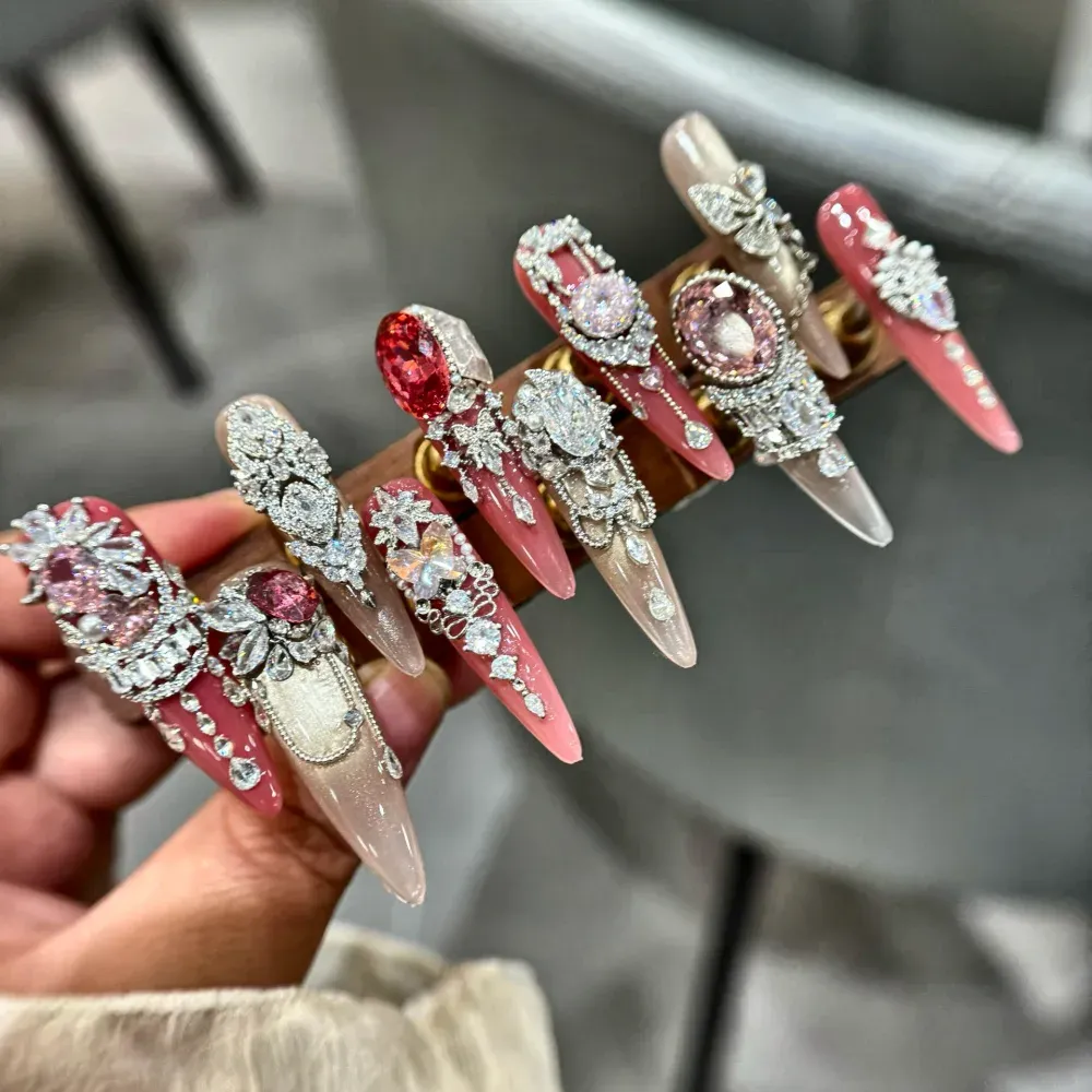Pink crystal rhinestone long stiletto press-on nails in coral pink and champagne nude with faceted crystals and 3D bows